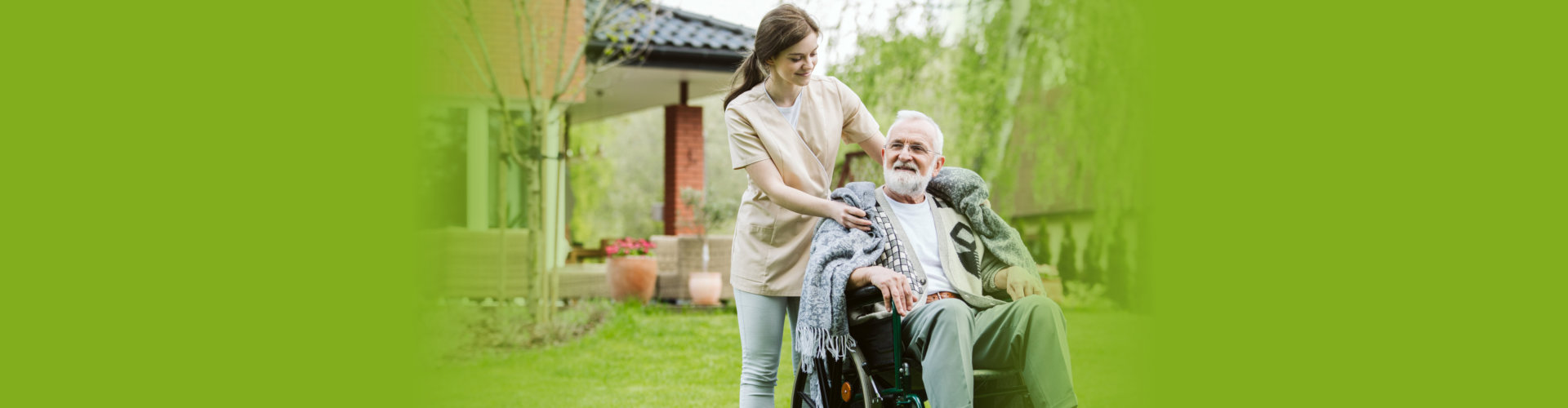 Senior with helpful caregiver in the garden